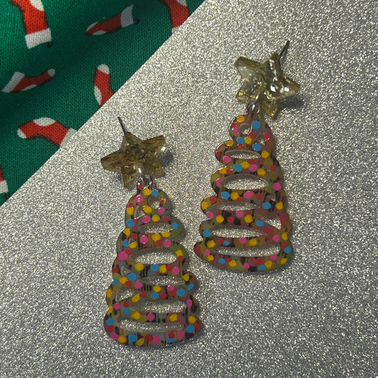 Colorful beaded earrings with star accents on a glittery surface.